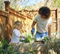 A woman and young girl gardening