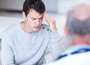 man talking to doctor about headache