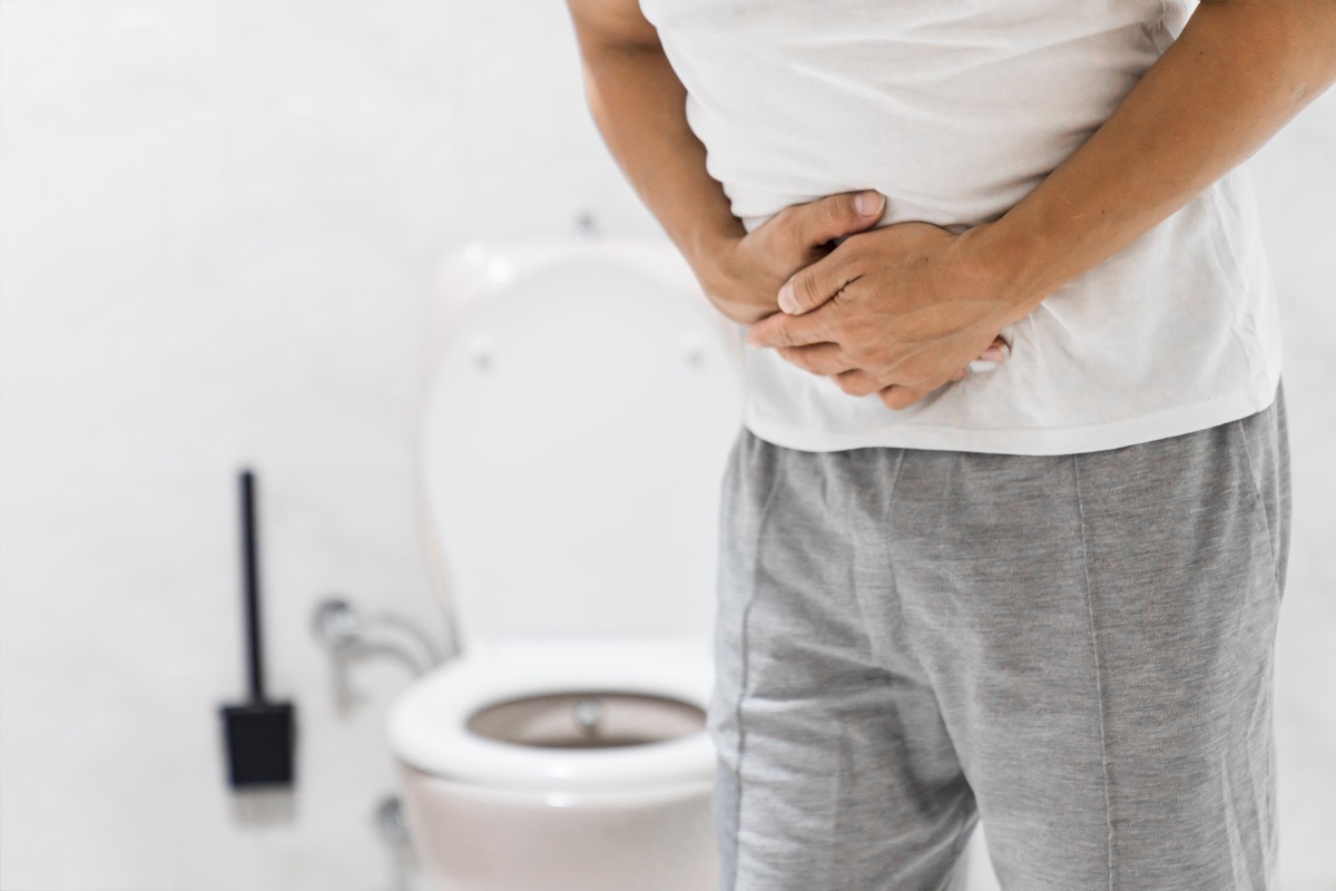 Men have stomachache and use their hands to hold their stomach In the bathroom. Constipation or colon cancer. diarrhea and severely toxic food. Man touch belly in the bathroom. Abdominal pain