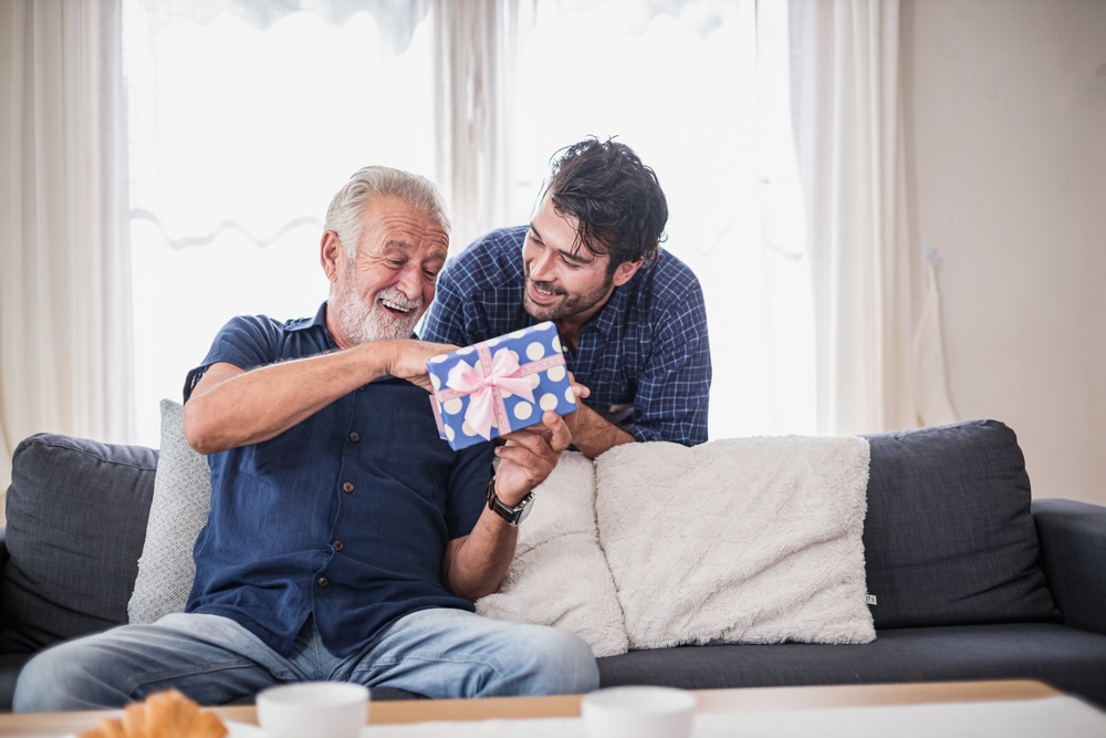 A young man giving an older man a gift