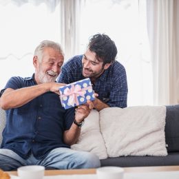 A young man giving an older man a gift