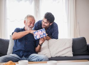 A young man giving an older man a gift