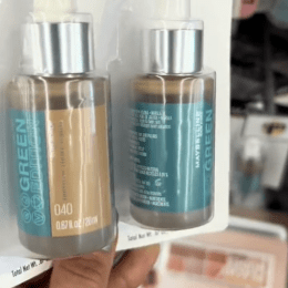 Dollar Tree shopper holding up a tubes of Maybelline makeup