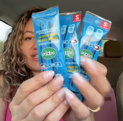 woman holding up Crest mouth fresheners Dollar Tree