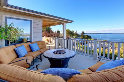 Cozy patio area with comfort settees and fire pit, overlooking the Puget Sound inTacoma, Washington