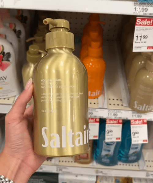 Shopper holding up a bottle of Saltair body wash at Target