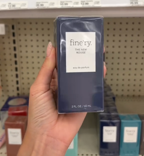 Shopper holding up a bottle of perfume at Target