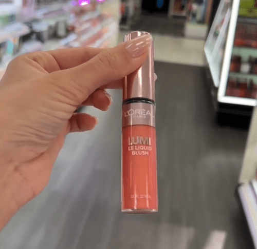 Shopper holding up lip gloss at Target