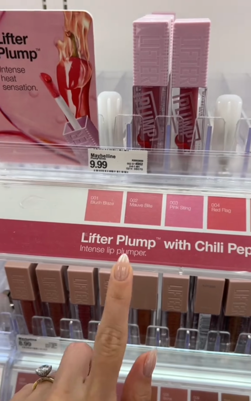 Shopper pointing to lip glosses at Target