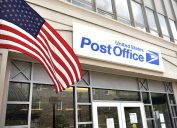 entrance to a post office with an American flag in front