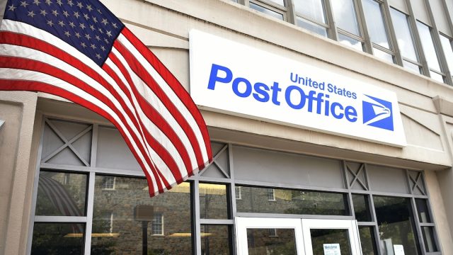 entrance to a post office with an American flag in front