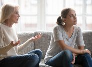 Young woman in argument with toxic mother on couch