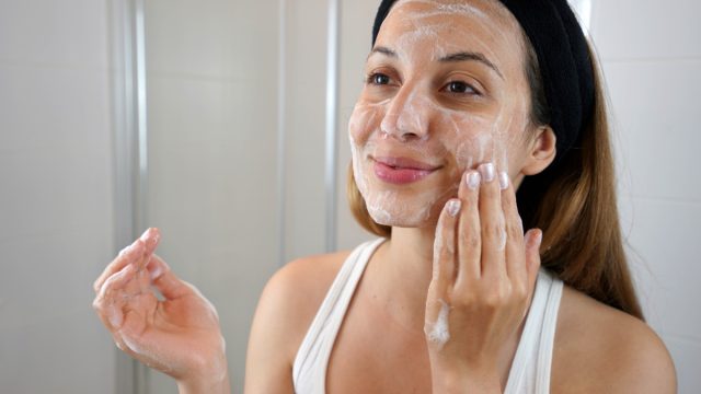 young woman exfoliating