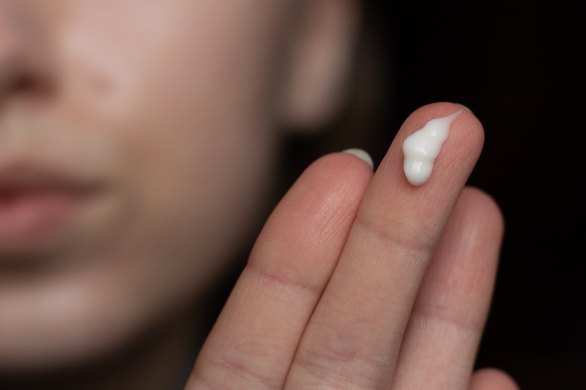 woman with retinoid cream on her fingers