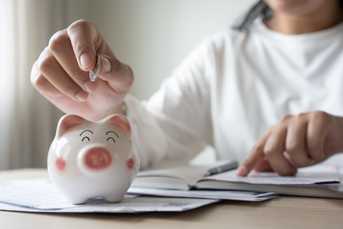 putting coin in piggy bank