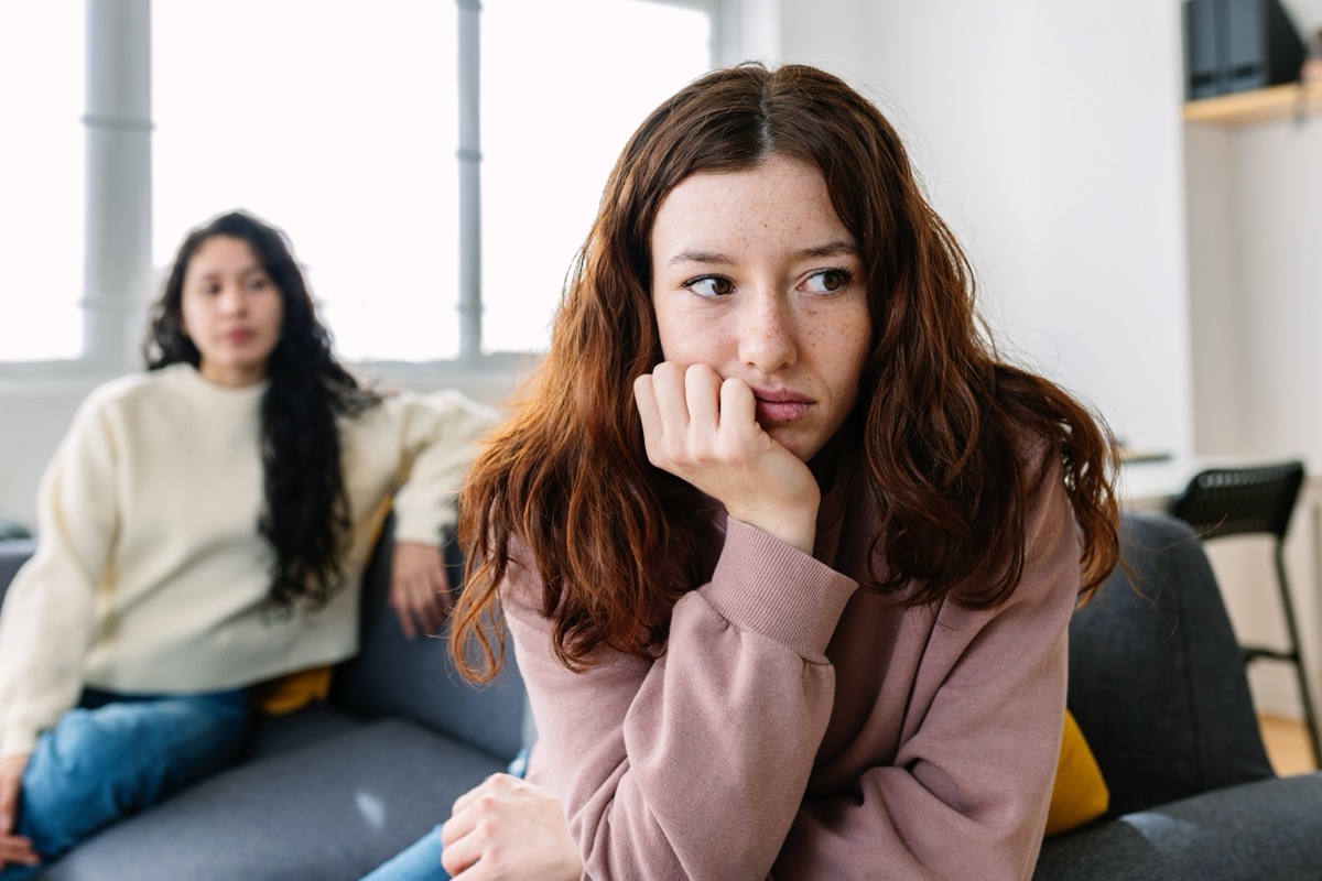 two female friends sitting separately after arguing