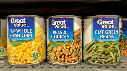 Grocery store shelf with cans of Great Value brand vegetables. Great Value is a Walmart brand product.