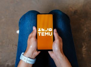 In this photo illustration, the Temu logo is displayed on a smartphone screen
