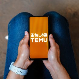In this photo illustration, the Temu logo is displayed on a smartphone screen