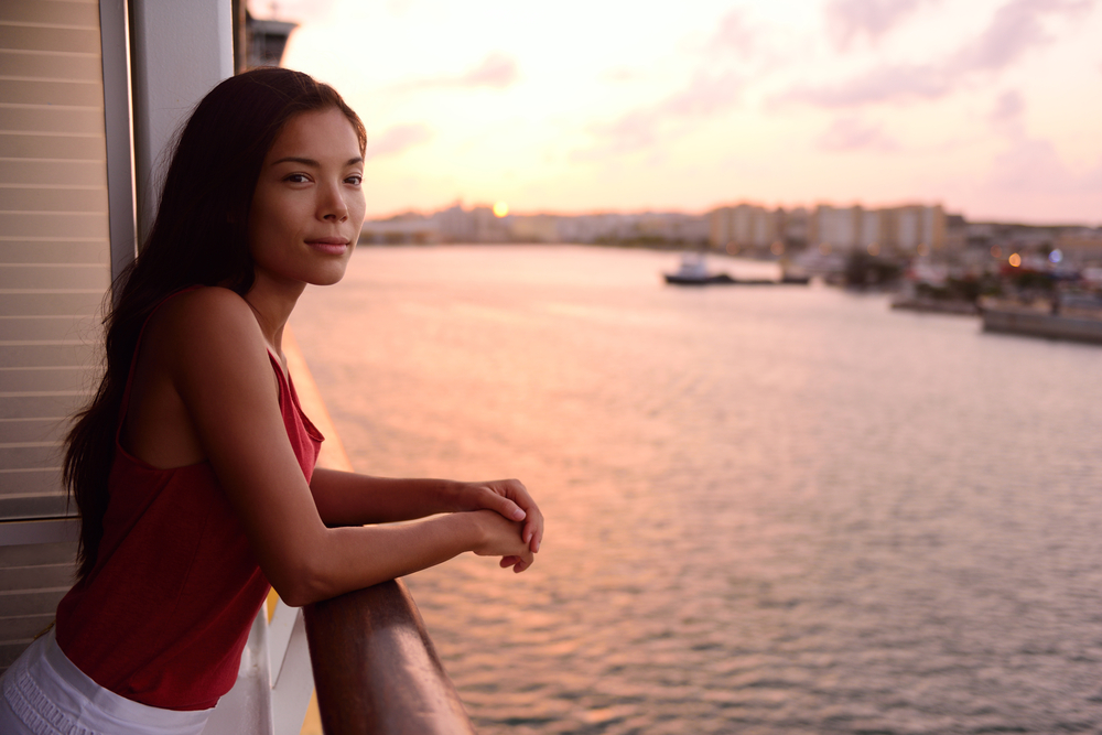 A woman on the balcony of a cruise ship