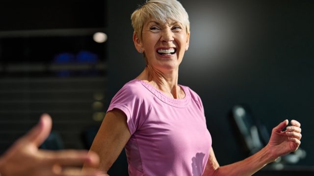 Portrait of a senior woman exercising in a gym, mature couple running using treadmill machine equipment, healthy lifestyle and cardio exercise at fitness club concepts, vitality and active senior