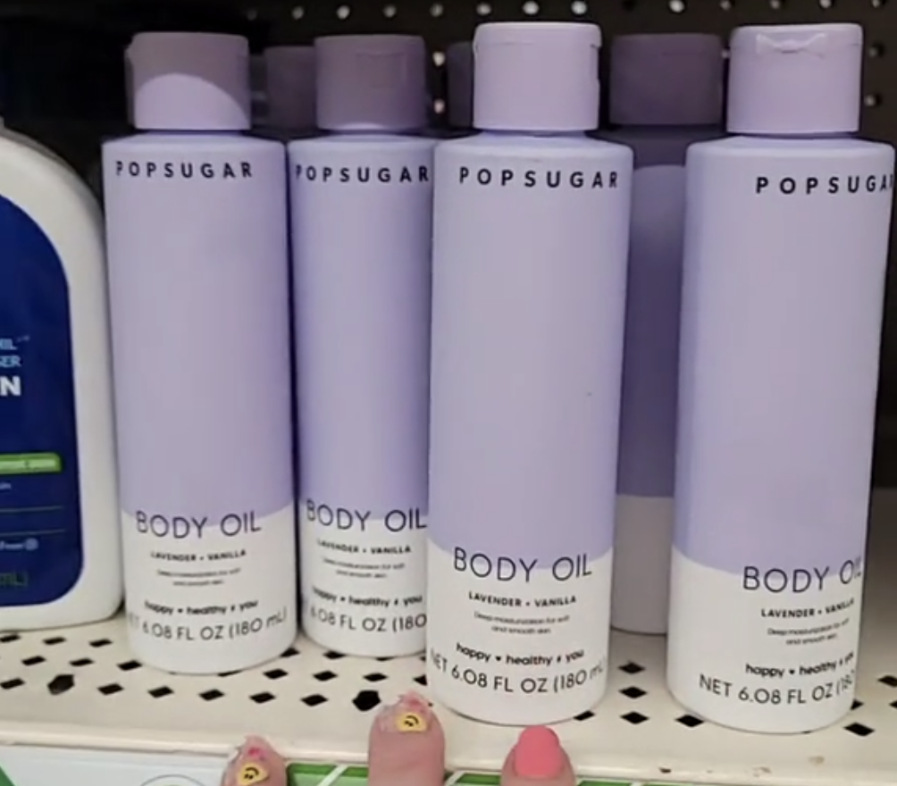 purple bottles of Popsugar body oil on display at Dollar Tree