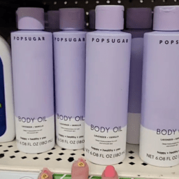 purple bottles of Popsugar body oil on display at Dollar Tree