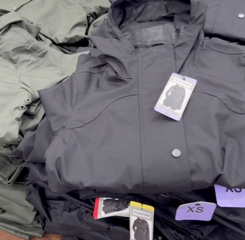 Closeup of navy blue Hunter rain jackets in a pile at Costco