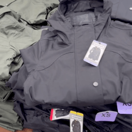 Closeup of navy blue Hunter rain jackets in a pile at Costco