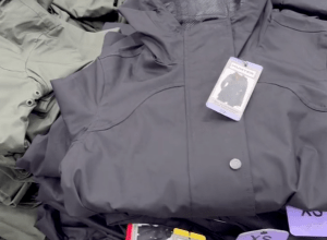 Closeup of navy blue Hunter rain jackets in a pile at Costco