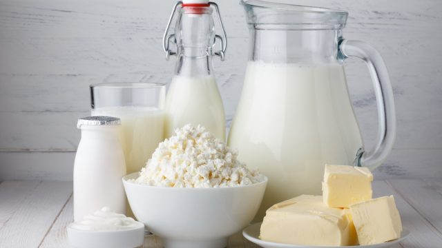 Dairy products on whitewashed wood background