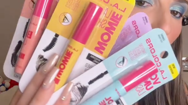 Woman holding up four L.A. Colors mascaras from Dollar Tree