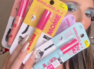 Woman holding up four L.A. Colors mascaras from Dollar Tree
