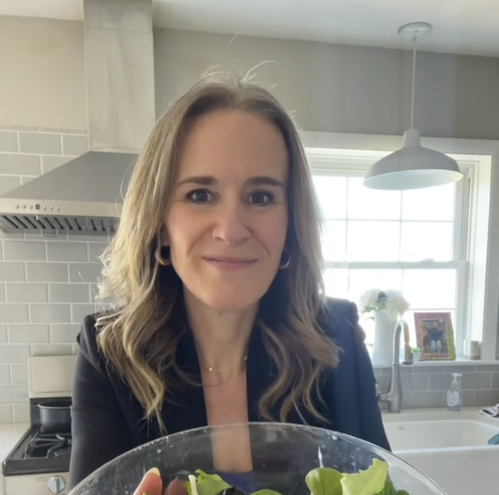 Woman standing in kitchen holding bowl