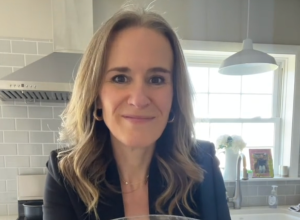 Woman standing in kitchen holding bowl