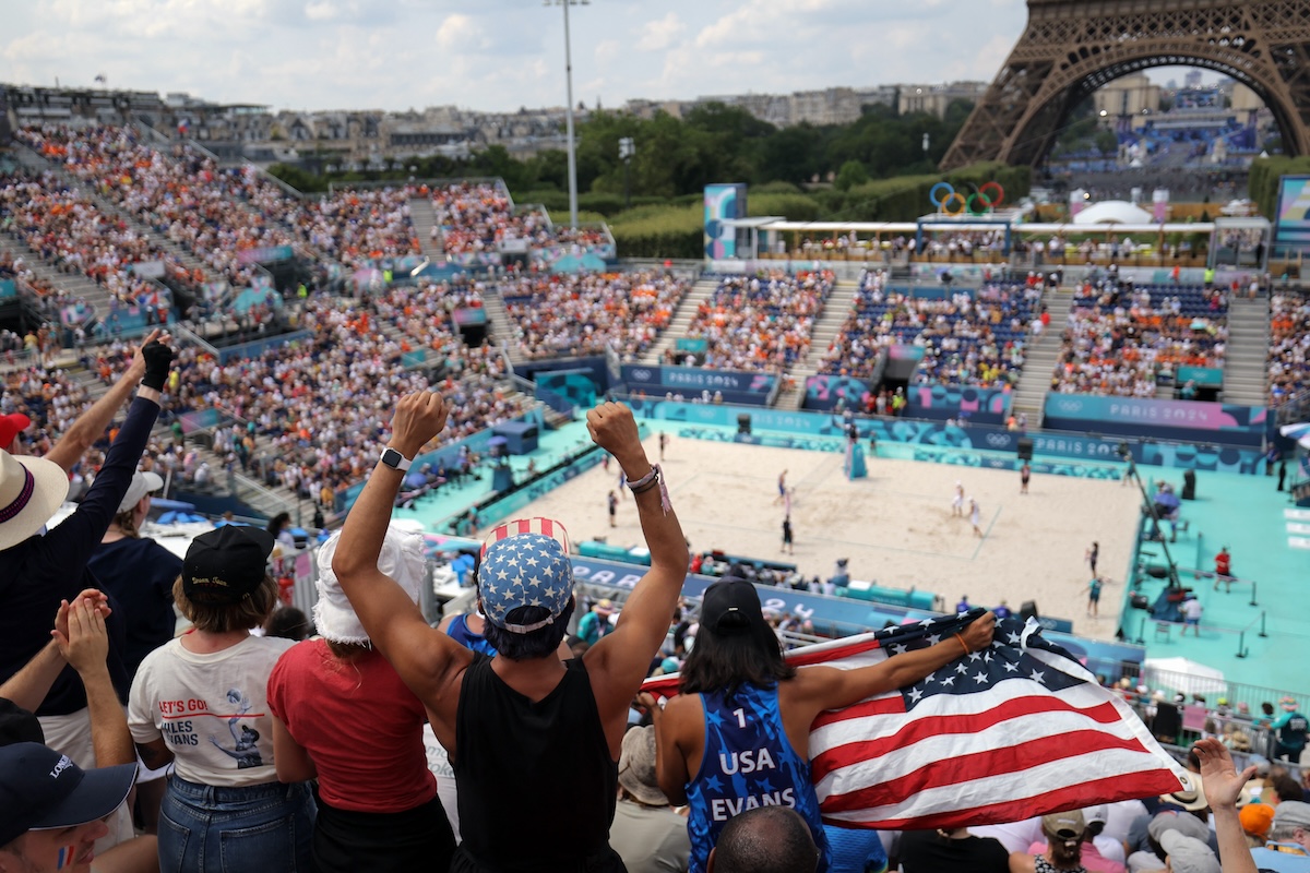 US' fans cheer for their country in the men's pool F beach volleyball match between Spain and USA during the Paris 2024 Olympic Games at the Eiffel Tower Stadium in Paris on August 2, 2024.