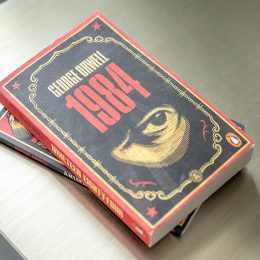 George Orwell's 1984 book on a coffee table.