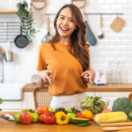 Portrait of beauty body slim healthy asian woman having fun cooking and preparing cooking vegan food healthy eat with fresh vegetable salad on counter in kitchen at home.Diet concept.Fitness, healthy