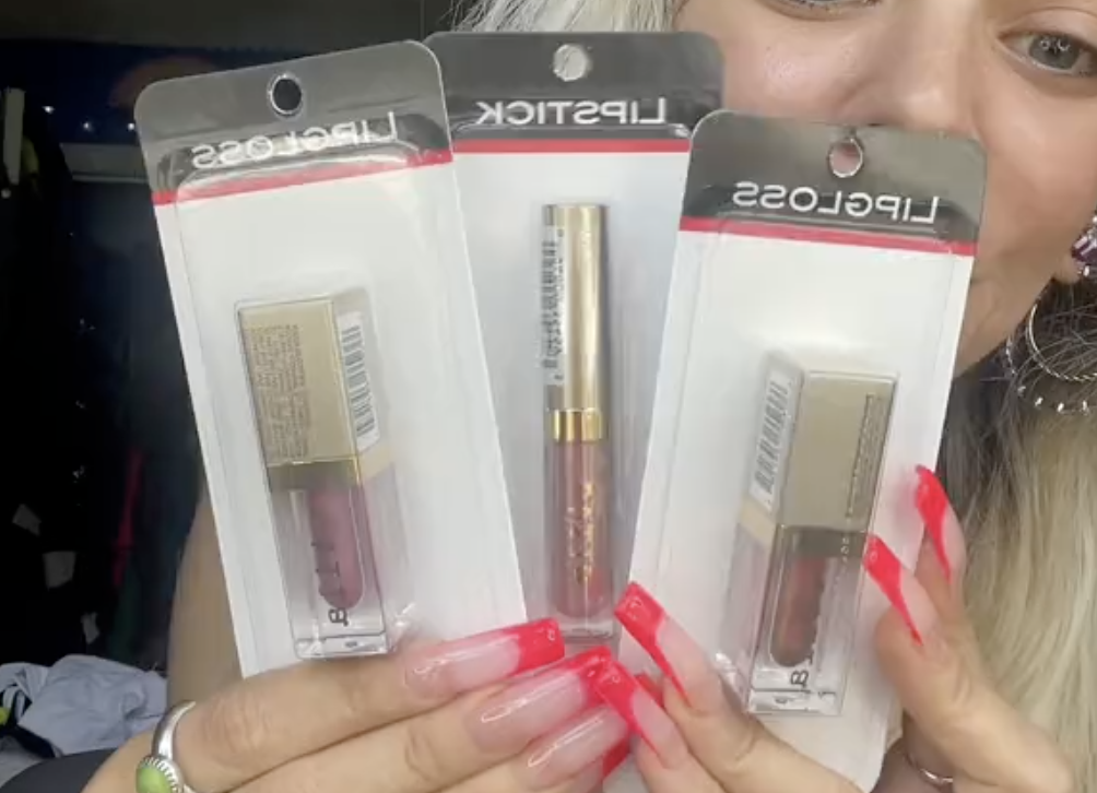 Shopper holding up Stila makeup from Dollar Tree