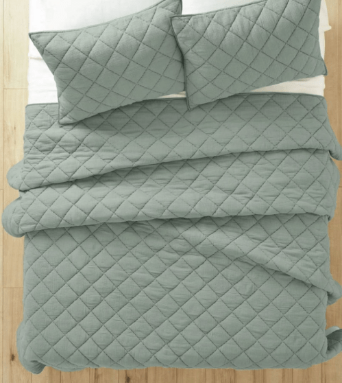 top-down view of a bed with Walmart's sage green diamond quilt