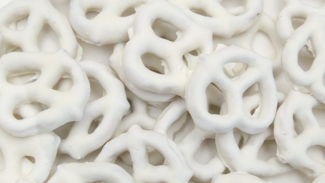 white chocolate covered pretzels on white background