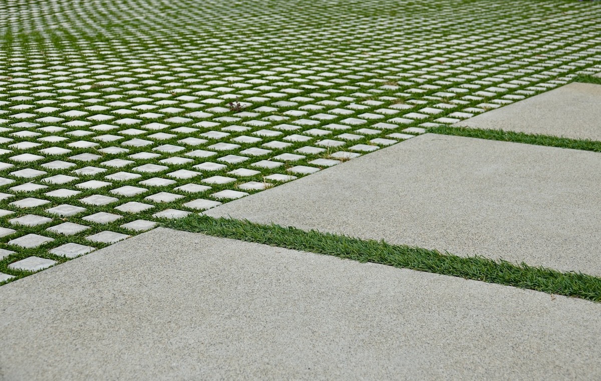 Closeup of a driveway that has pavers and grass