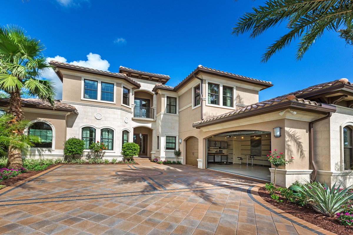 Mediterranean-style house with large paved driveway