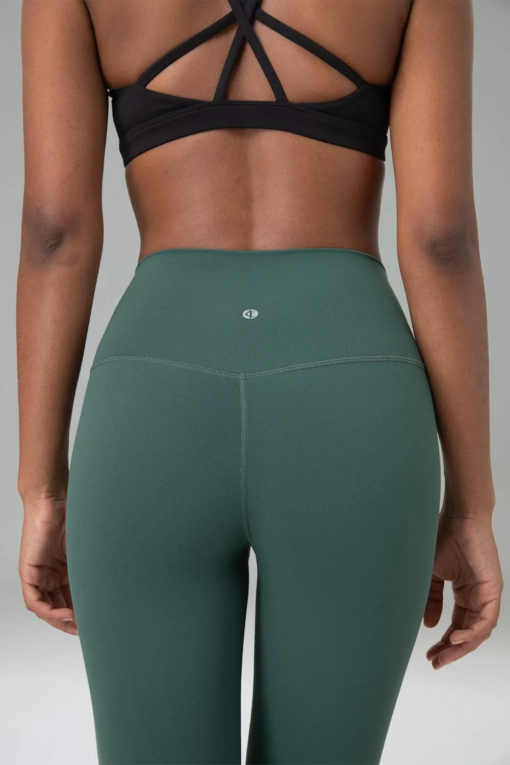 rear closeup of a woman wearing sage green leggings