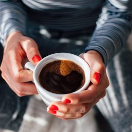 Woman holding cup of coffee