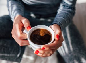 Woman holding cup of coffee