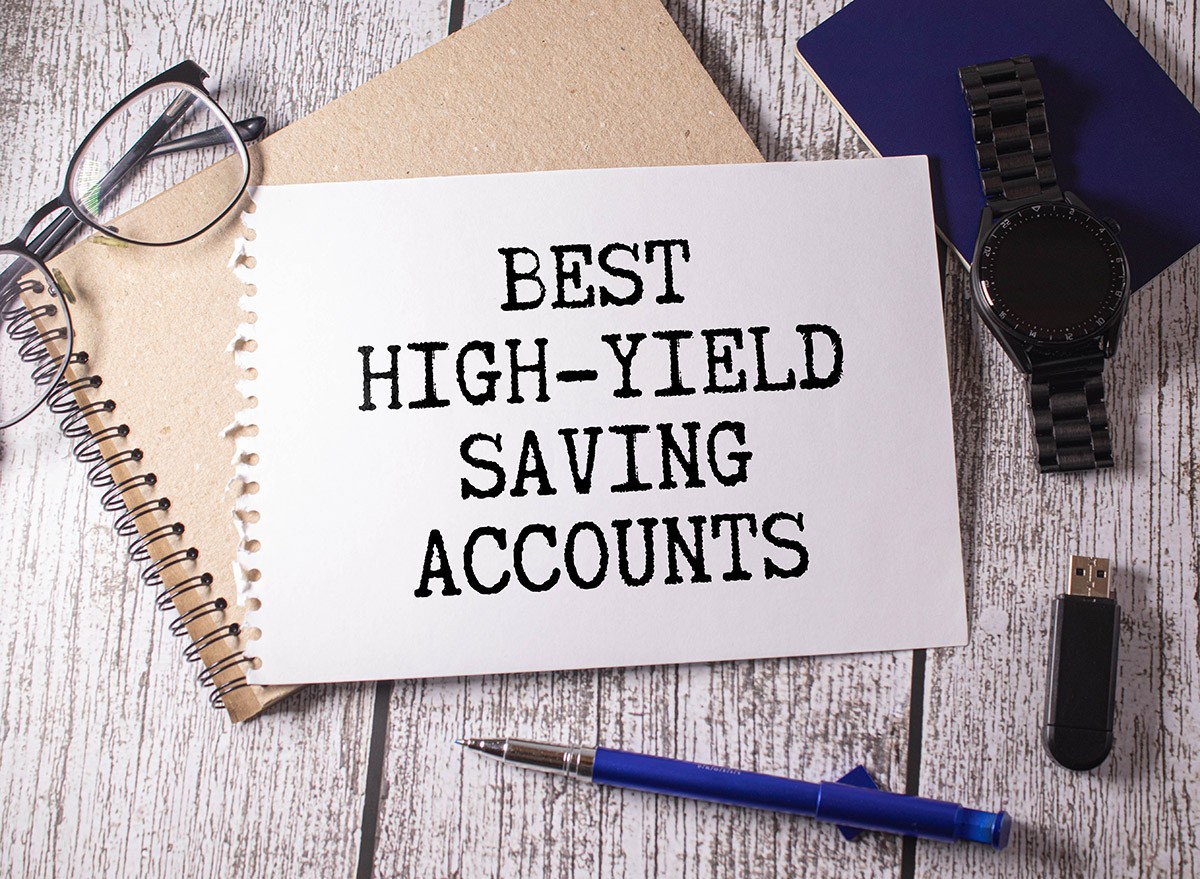 A book on a desk with a page ripped out that reads, 'Best High-Yield Saving Accounts'.