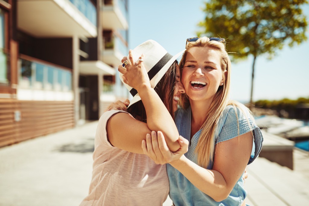 Two female friends laughing together.