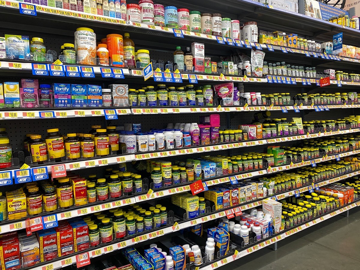 The Vitamin and Supplement aisle of a Walmart Superstore with a variety of supplemental pill and capsule products from various manufacturers.