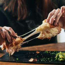 10 Signs You’re Eating Too Much Cheese, According to Doctors